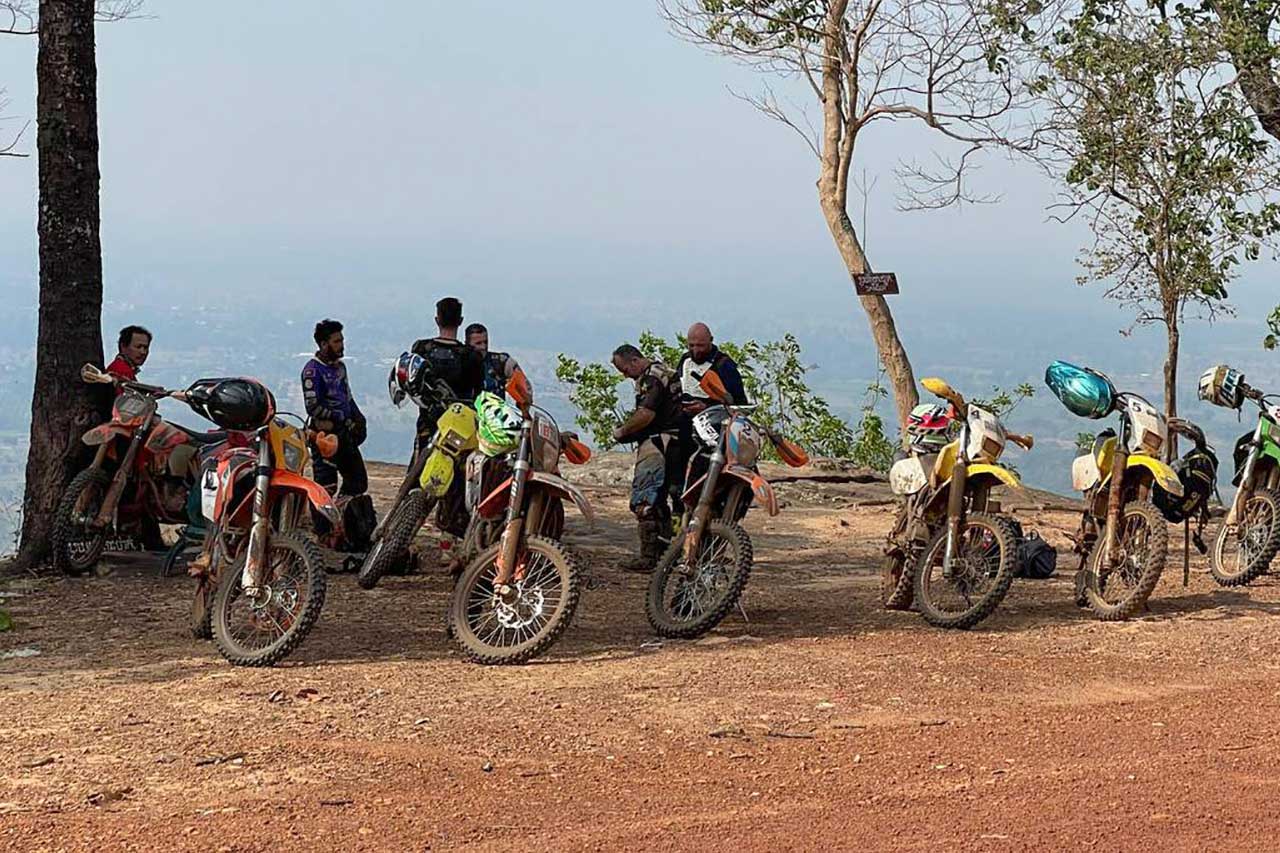 6Guys-stading-with-their-dirtbikes-at-Alungveng-hill-in-Cambodia